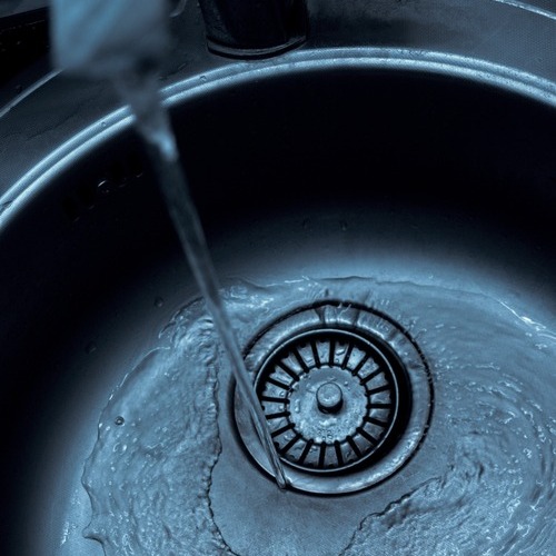 water being poured from a tap in a sink